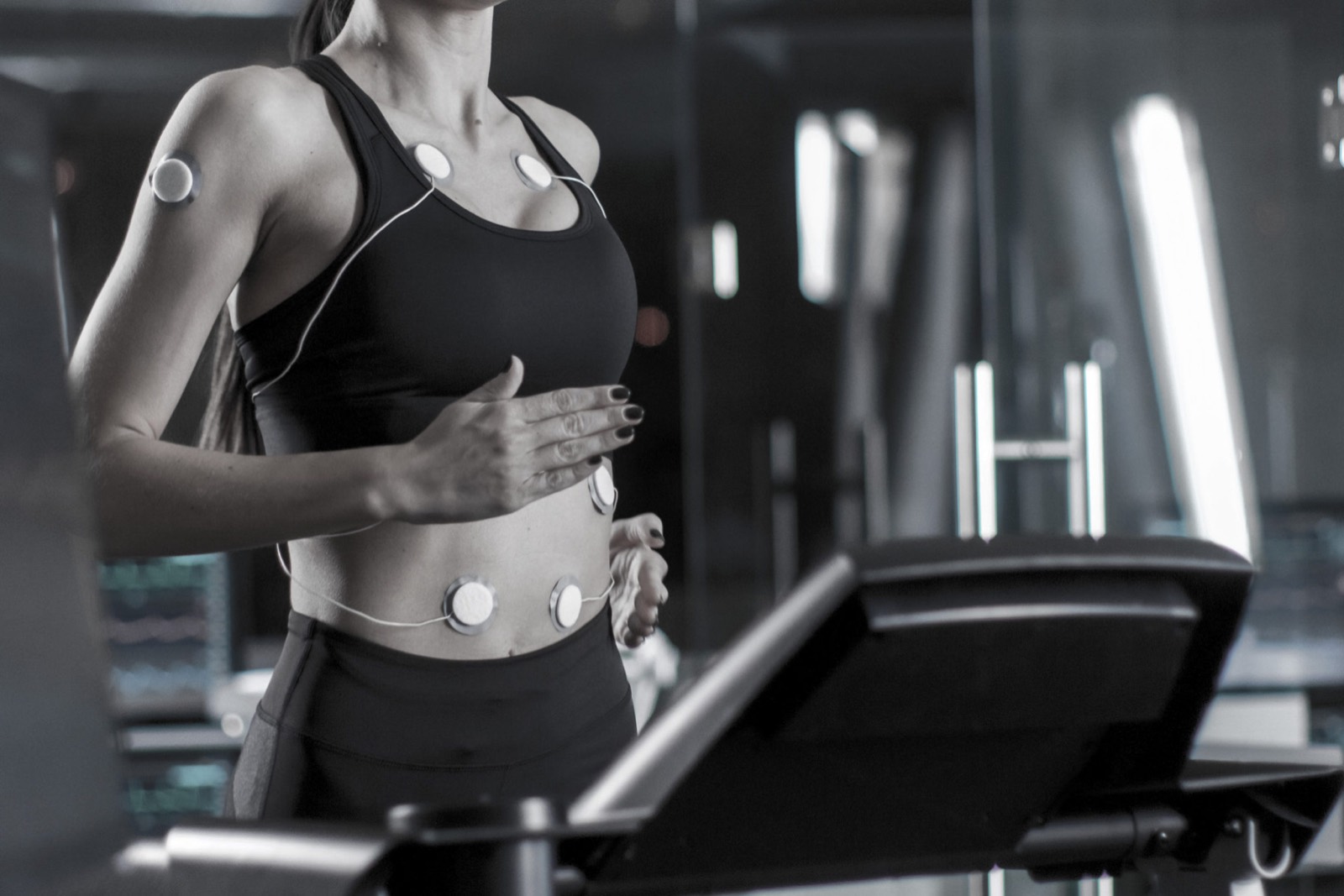 Sports science testing: a runner wearing sensors on a treadmill